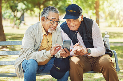 Buy stock photo Elderly men, friends and phone in park, reading and army memory with thinking, relax and sunshine. Senior military veteran, smartphone social media and talk on bench, nostalgia and remember service