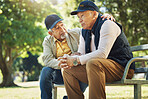 Elderly men, park and comfort with friends, nature and communication with support in retirement. Diversity, closeup and senior people in conversation with friend, together and care on bench in summer