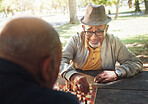 Happy, senior and game of chess outdoor with friends playing with strategy or thinking challenge in retirement. Winning, boardgame and elderly person with king in checkmate in park, woods or nature