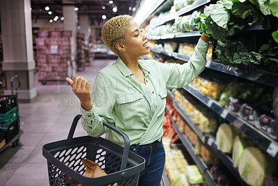 Buy stock photo Woman, grocery shopping and vegetables choice, discount and sale or wholesale promotion of healthy food in basket. Happy African customer with spinach in retail, convenience store or supermarket deal