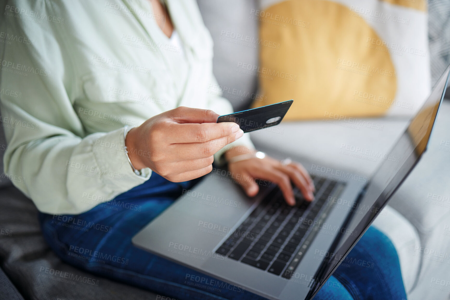 Buy stock photo Hands, laptop and credit card for home online shopping, fintech payment and e commerce on sofa. Closeup of person typing on computer for internet banking, website subscription or application for loan