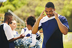 Cheerleader, fitness injury and man headache from sport, training and cheer exercise on a grass field. Stress, accident and burnout outdoor with migraine pain and workout challenge for wellness
