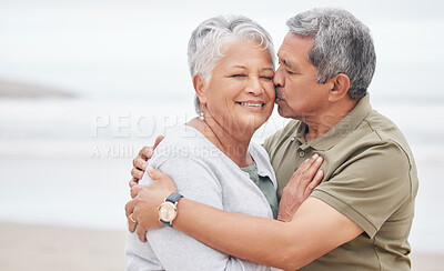 Buy stock photo Senior couple, kiss and love at beach for holiday, vacation and tropical travel in retirement. Happy man, elderly woman and hug of affection at ocean for trust, support and loyalty to partner on date