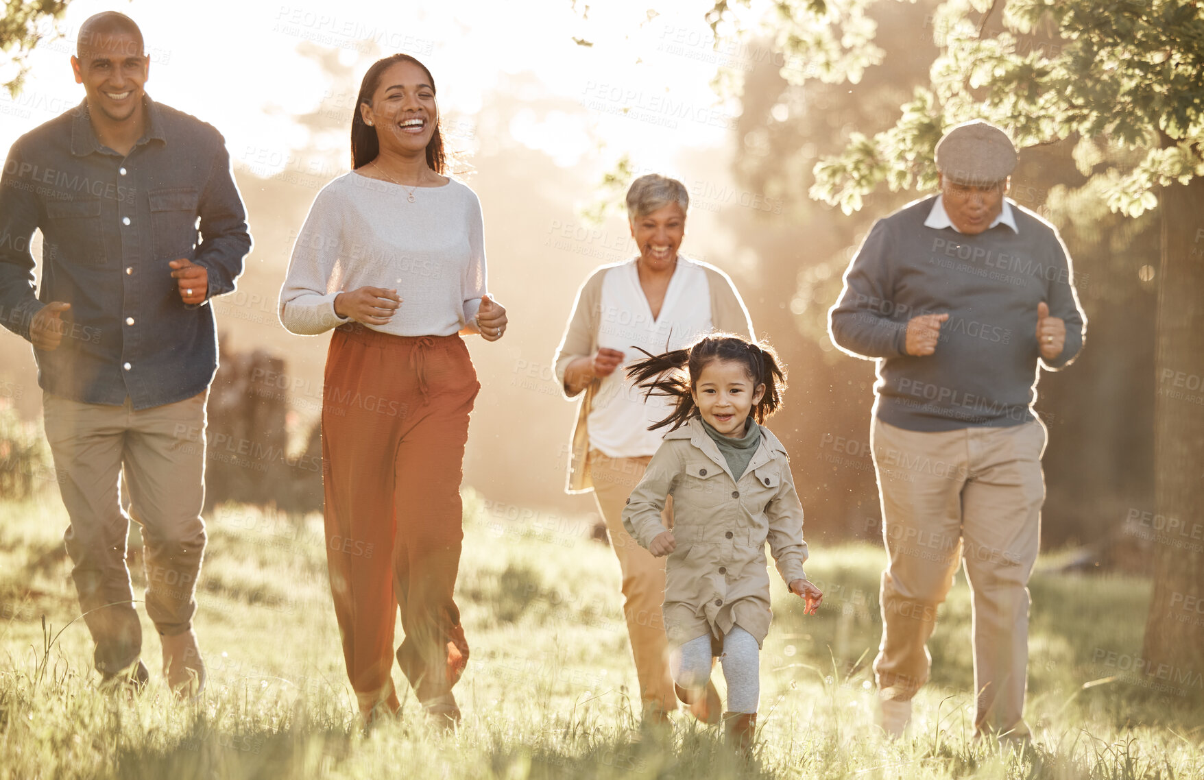 Buy stock photo Park, running and child with parents or grandparents on grass field for freedom, adventure or playing in summer. Family, men or women with fun or love in forest with sunshine for care or happiness