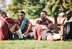 Sports, huddle and rugby players in a circle at training for planning strategy for game or match. Fitness, group and athletes talking for team building and motivation on an outdoor field for practice