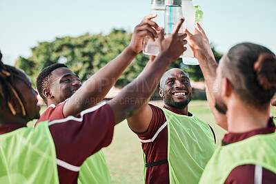 Buy stock photo Soccer team, water bottle and cheers with teamwork, achievement and community on grass field. Fitness, workout and sport training of men group with smile and celebration from game outdoor with drink