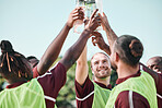 Soccer team, water bottle and toast with teamwork, achievement and support on grass field. Fitness, workout and sport training of men group with smile and celebration from game outdoor with drink