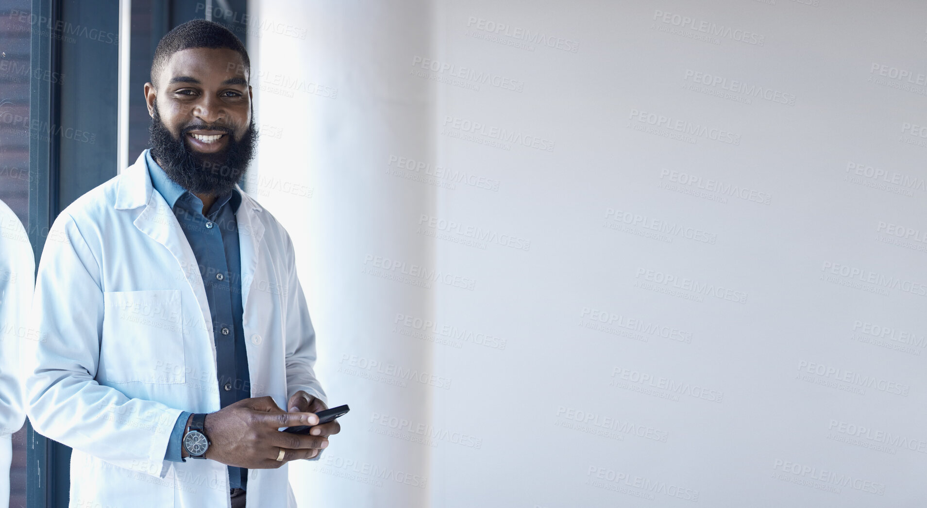 Buy stock photo African doctor, man and portrait with space for mock up, promotion and using phone for networking in clinic. Male medic, smartphone and texting with smile, communication and notification in hospital