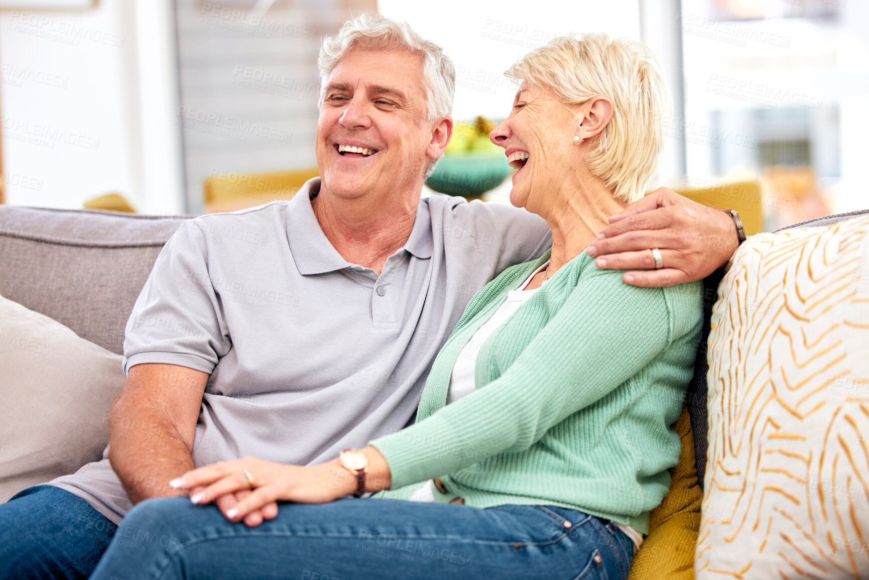 Buy stock photo Funny, laughing or happy senior couple with love, care or joy together on sofa at home in retirement. Relax, silly joke or mature people hug with support, humor or loyalty on house living room couch