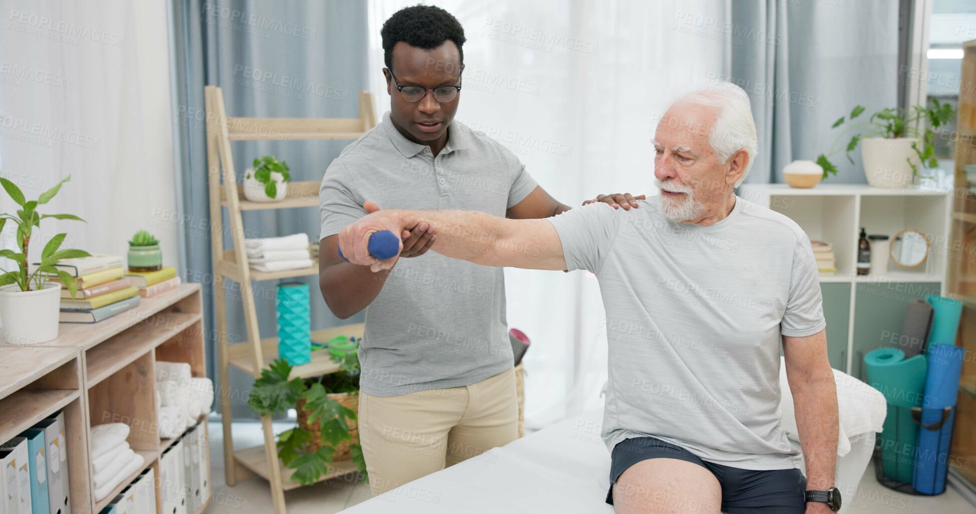Buy stock photo Arm physiotherapy, dumbbell or person with old man for support, recovery in motion training. Physical therapy, rehabilitation or African physiotherapist helping elderly patient with mobility exercise