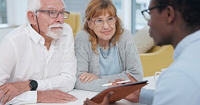 Senior couple with a male financial advisor by a table in the dining room of their modern house. Conversation, meeting and elderly man and woman planning their retirement fund with accountant at home