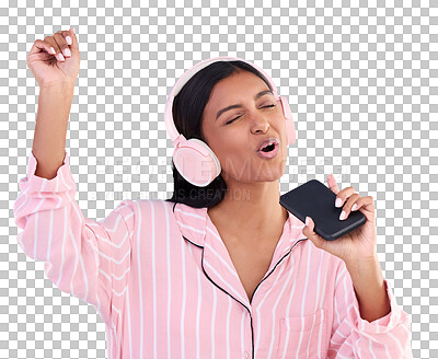 Singing, music and a woman in pyjamas with headphones isolated on a blue background in a studio. Happy, playful and a girl listening to the radio, audio or streaming songs before bedtime on a mobile