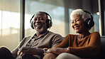 Senior couple listen to music with headphones on vacation on sunny day, beach vacation or retirement