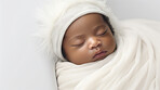 Closeup of sleeping newborn boy baby. Portrait of baby wrapped in blanket