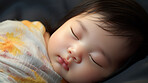 Closeup of sleeping newborn boy baby. Portrait of baby wrapped in blanket