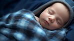 Closeup of sleeping newborn boy baby. Portrait of baby wrapped in blanket