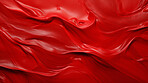 Red smooth paint texture close-up. Swirl abstract background.
