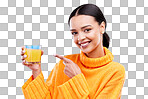 Happy woman, portrait and pointing to orange juice in studio, blue background and backdrop. Female model, drinking glass and fruit cocktail beverage for nutrition, diet and detox health of vitamin c