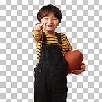 Cute little mixed race boy smiling and pointing while holding a football and posing against an orange copyspace background