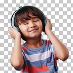 A cute young asian boy enjoying listening to music from his wireless headphones. Adorable Chinese kid smiling and feeling the magic of music while posing against an blue studio background