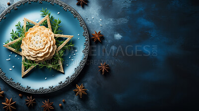 Top view of traditional jewish food in shape of star of David on blue table with copy space .