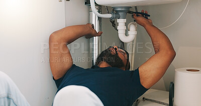 Plumber black man, kitchen and sink maintenance with tools, focus and pipe repair for drainage in home. Entrepreneur handyman, plumbing expert or small business owner in house for fixing water system