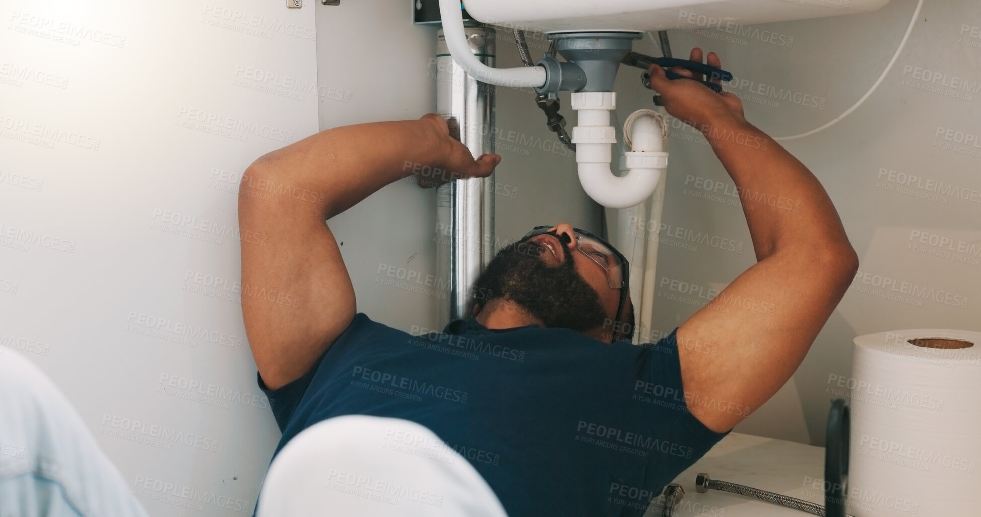 Buy stock photo Plumber black man, kitchen and sink maintenance with tools, focus and pipe repair for drainage in home. Entrepreneur handyman, plumbing expert or small business owner in house for fixing water system