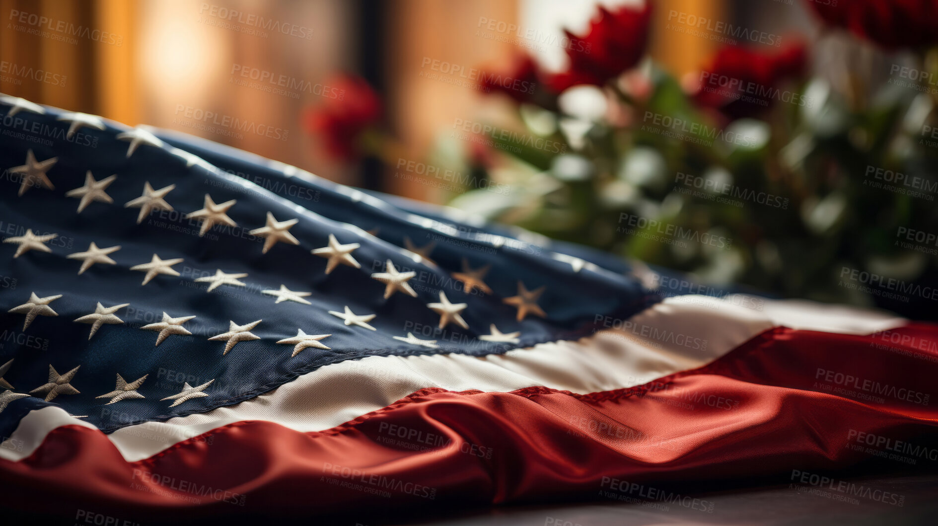 Buy stock photo American flag on table with flowers in background. Patriotic symbolism concept.