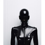 Female robot in futuristic fashion concept. Wearing black 
leather on white backdrop.