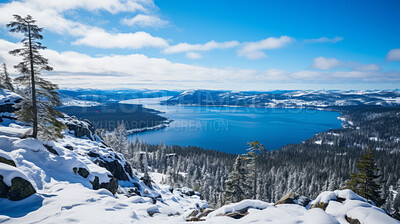 High mountain view of beautiful lake in winter. Forest, ground covered in snow.