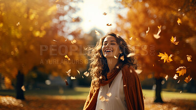 Joyful young woman happy in falling autumn leaves. Cheerful female walking in a park.