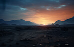 Sun rising over remote desert landscape. Cloudy, orange sky.