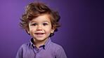 Portrait of a toddler posing against a purple background. happy smiling boy