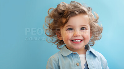 Buy stock photo Portrait of a toddler posing against a blue background. happy smiling girl