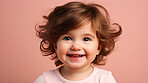 Portrait of a toddler posing against a pink background. happy smiling girl