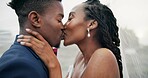 Outdoor, kiss and black couple with marriage, wedding and hug with happiness, romance and celebration. African man, happy woman and embrace outside, love and bride with groom, romantic and commitment