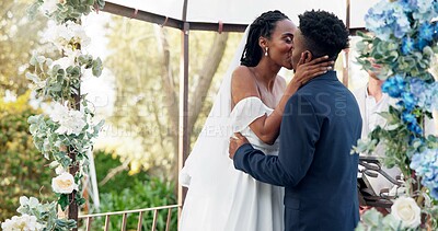 Happy black couple, wedding and kiss for love, marriage or commitment in support together. Married African woman and man kissing in embrace, trust or relationship of bride or groom in outdoor romance