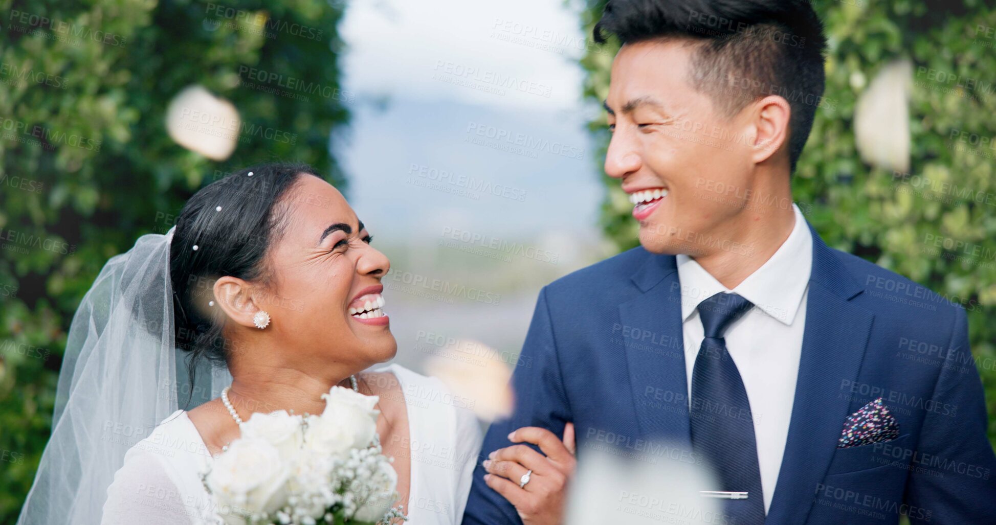 Buy stock photo Couple, flower confetti and wedding event with walk, outdoor or happy laugh in nature. Woman, Asian man and excited for marriage, floral bouquet and love with care in park, party or together in aisle