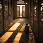 Religious man praying in mosque during sunset. Religious concept.