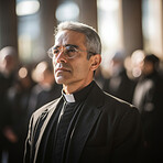 Close up portrait of senior priest standing in church. Wearing clergy collar. Religion concept.