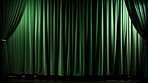 Empty theater stage with green velvet curtains. Spotlight showtime copy space