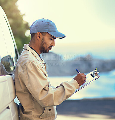 Buy stock photo Cropped shot of a delivery man writing on a clipboard while standing next to his van