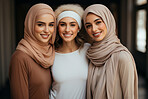 Three empowered muslim women posing. Wearing hijab and smiling. Religion concept