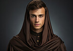 Studio portrait of young priest. Wearing monk robe. Religion concept