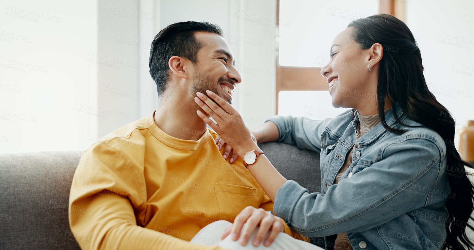 Buy stock photo Happy, eye contact and couple relax, love and smile for weekend bond, care or connect with boyfriend, girlfriend or partner. Wellness, comfort and romantic man, woman or people on living room couch