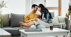 Couple, relax and romance on sofa, talk and happy in home living room, bonding and funny joke. Man, woman and smile together with intimate chat, care and comic conversation on lounge couch in house