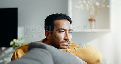 Buy stock photo Thinking, memory and sad asian man on a sofa with nostalgia, depression or grief in his home. Burnout, worry and Japanese male in living room with broken heart, mourning or anxiety for loss and debt
