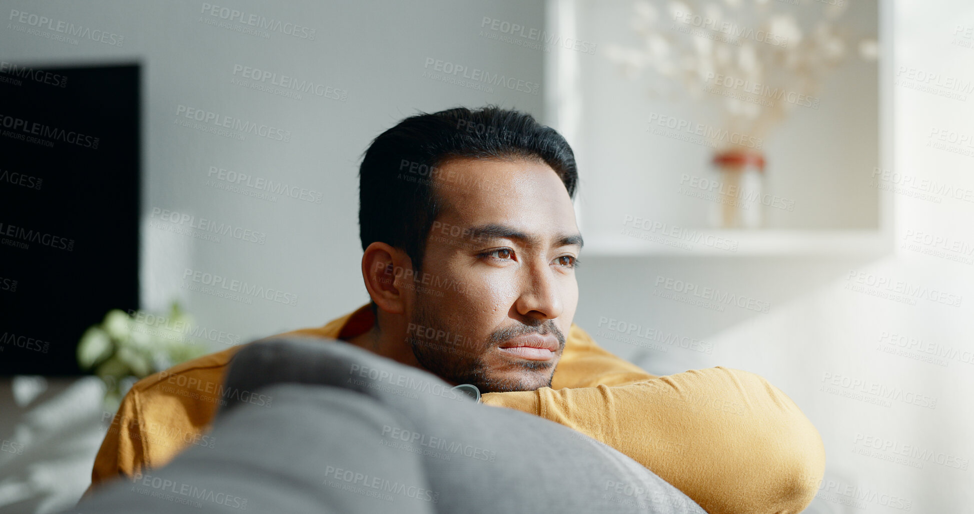 Buy stock photo Asian, man and thinking or sad on sofa for broken heart, grief or memory. Male person, thoughts or nostalgia depression or stress crisis alone or tired remember, mistake or mental health in lounge