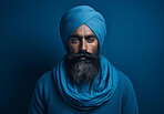 Sikh Indian man wearing traditional blue turban. Studio portrait. Religion concept.