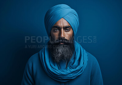 Sikh Indian man wearing traditional blue turban. Studio portrait. Religion concept.